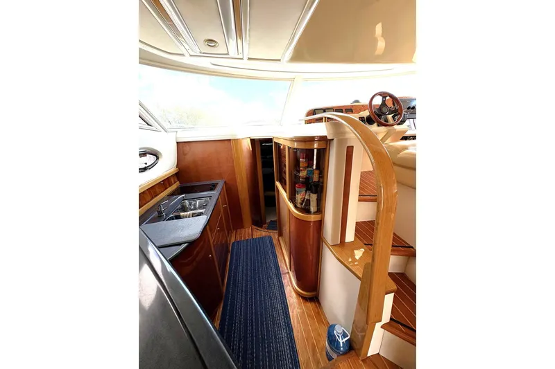 Pilot House Yacht Photos Pics Luxurious 2003 Sealine F42/5 yacht interior with wooden finishes and modern amenities.