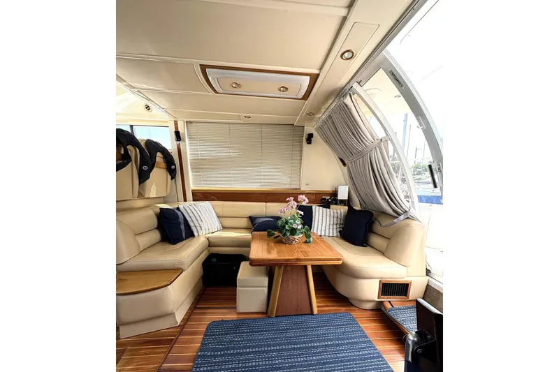 Pilot House Yacht Photos Pics Luxurious 2003 Sealine F42/5 yacht interior with elegant seating and wooden table.