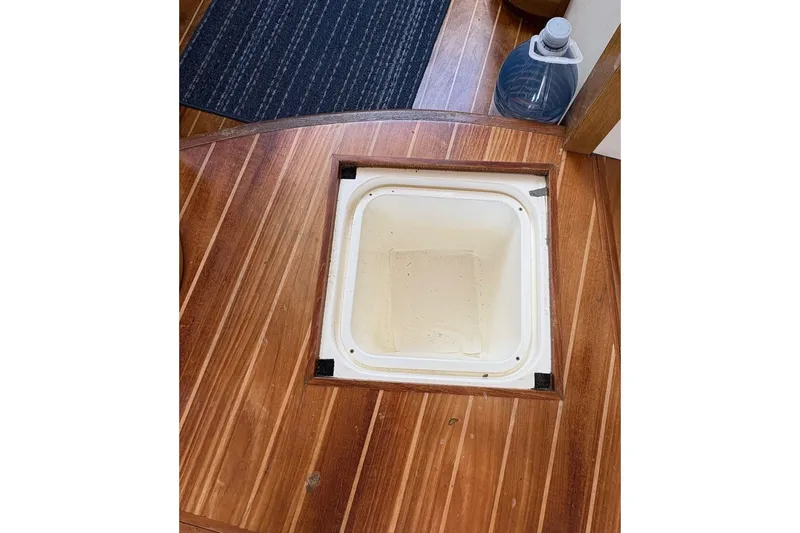 Pilot House Yacht Photos Pics Wooden floor hatch on 2003 Sealine F42/5 boat, with storage compartment.