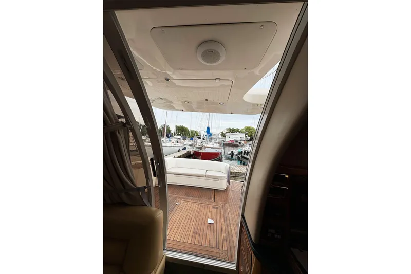 Pilot House Yacht Photos Pics 2003 Sealine F42/5 yacht interior view with open deck and marina background.