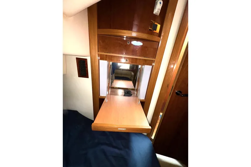 Pilot House Yacht Photos Pics 2003 Sealine F42/5 yacht interior with wooden cabinetry and fold-out table.