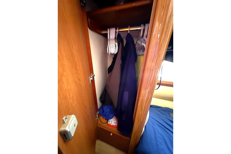 Pilot House Yacht Photos Pics Closet interior on 2003 Sealine F42/5 yacht with hanging clothes and storage.