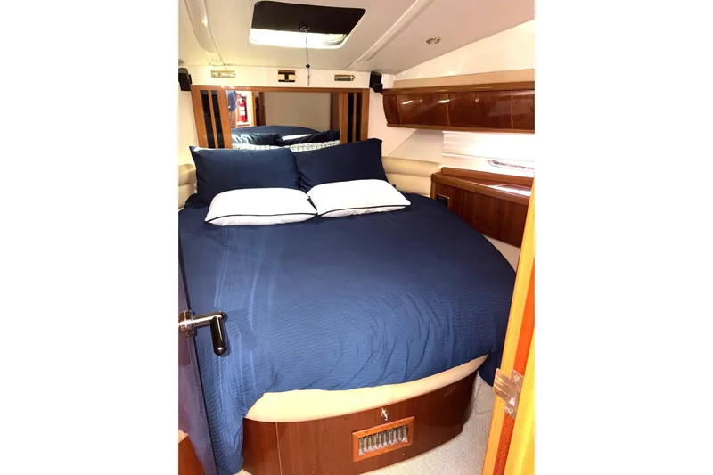 Pilot House Yacht Photos Pics Luxurious cabin interior of 2003 Sealine F42/5 yacht with blue bedding.