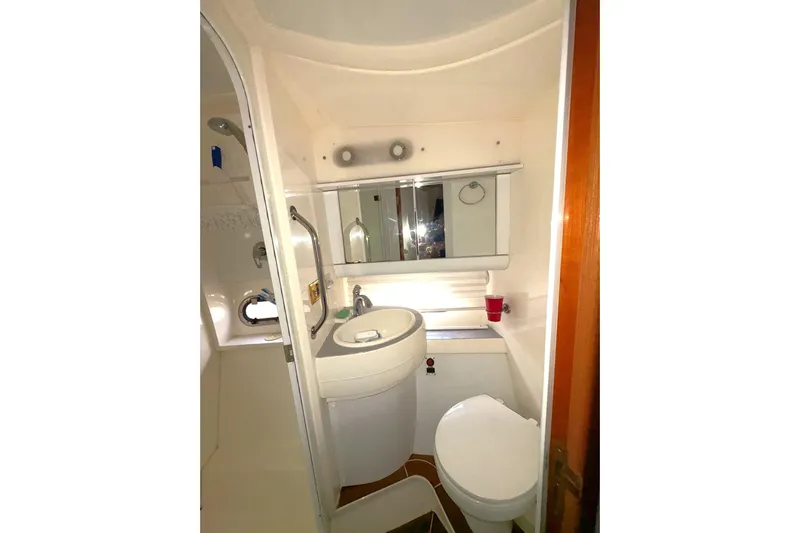Pilot House Yacht Photos Pics Bathroom interior of 2003 Sealine F42/5 yacht with sink, toilet, and mirror.