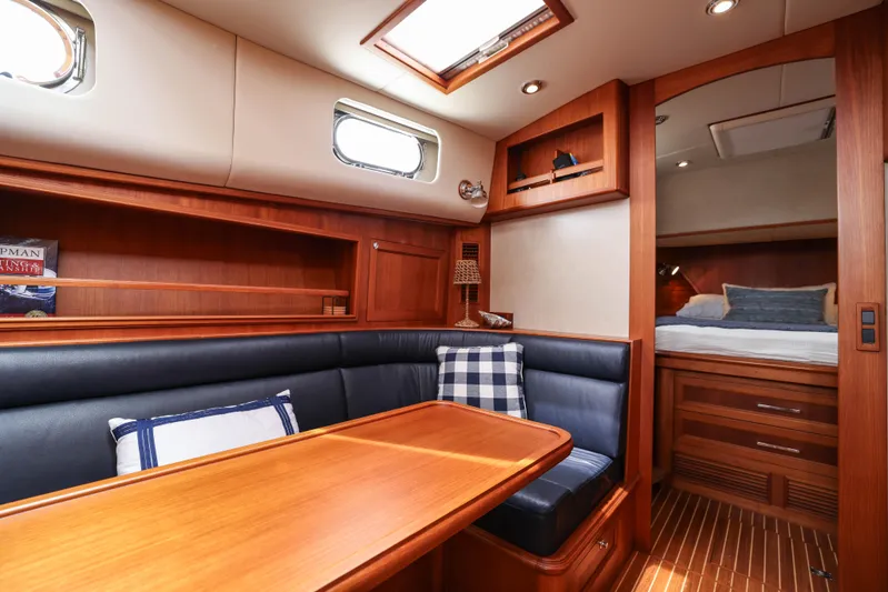 Aryeh Yacht Photos Pics Luxurious 2008 Grand Banks EASTBAY 39 SX yacht interior with wood finish and cozy seating area.