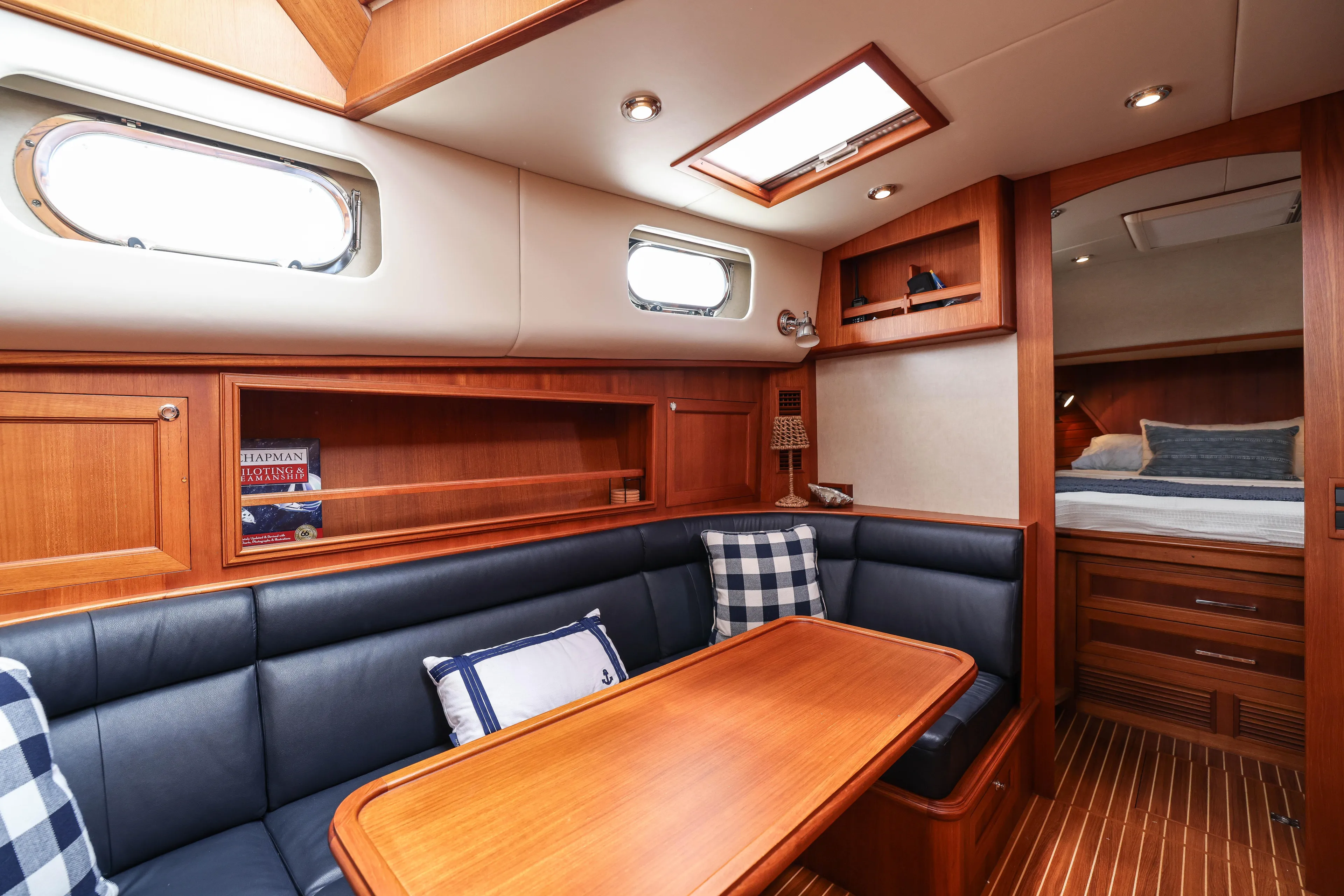 Aryeh Yacht Photos Pics Luxurious interior of 2008 Grand Banks EASTBAY 39 SX yacht with wood finish and seating area.