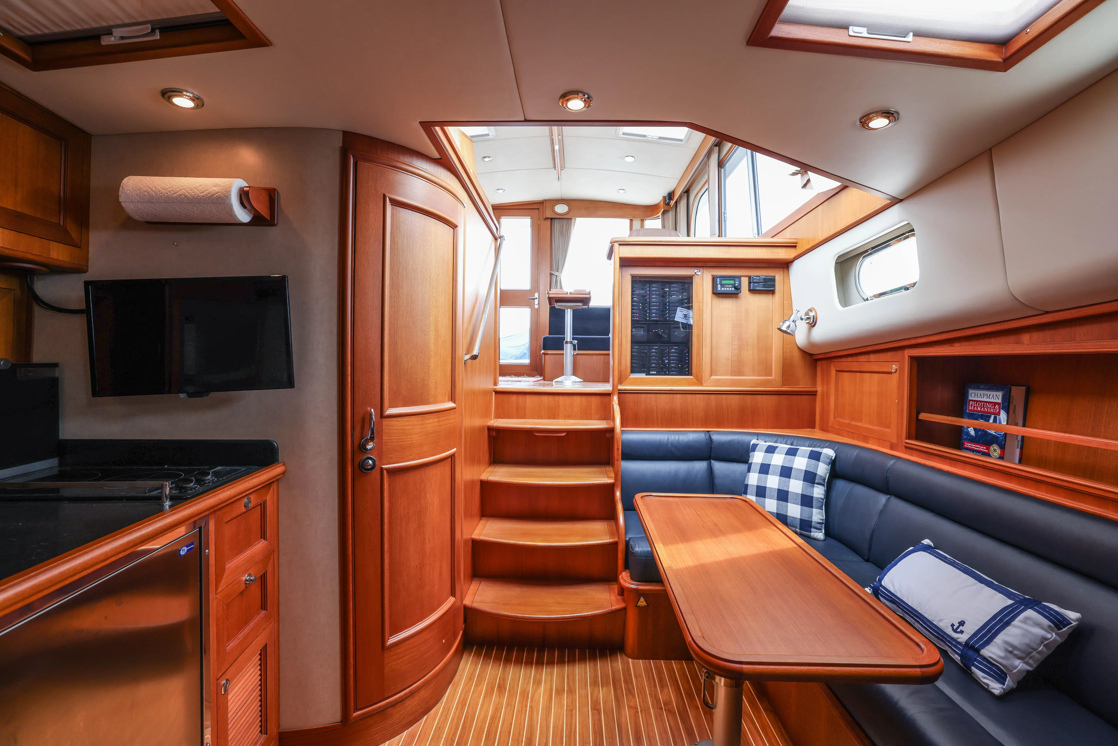 Aryeh Yacht Photos Pics Luxurious interior of 2008 Grand Banks EASTBAY 39 SX yacht with wood finish and seating area.
