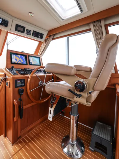 Aryeh Yacht Photos Pics Helm station of 2008 Grand Banks EASTBAY 39 SX with navigation equipment and captain's chair.