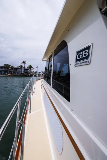 Aryeh Yacht Photos Pics 2008 Grand Banks EASTBAY 39 SX yacht, side view, cruising near waterfront homes.