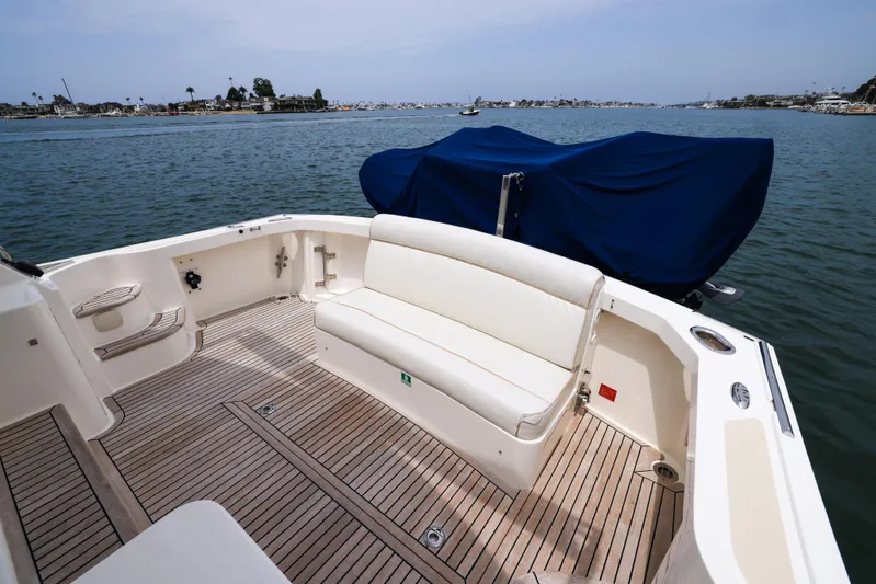 Aryeh Yacht Photos Pics 2008 Grand Banks EASTBAY 39 SX yacht with spacious deck and seating, docked on calm waters.