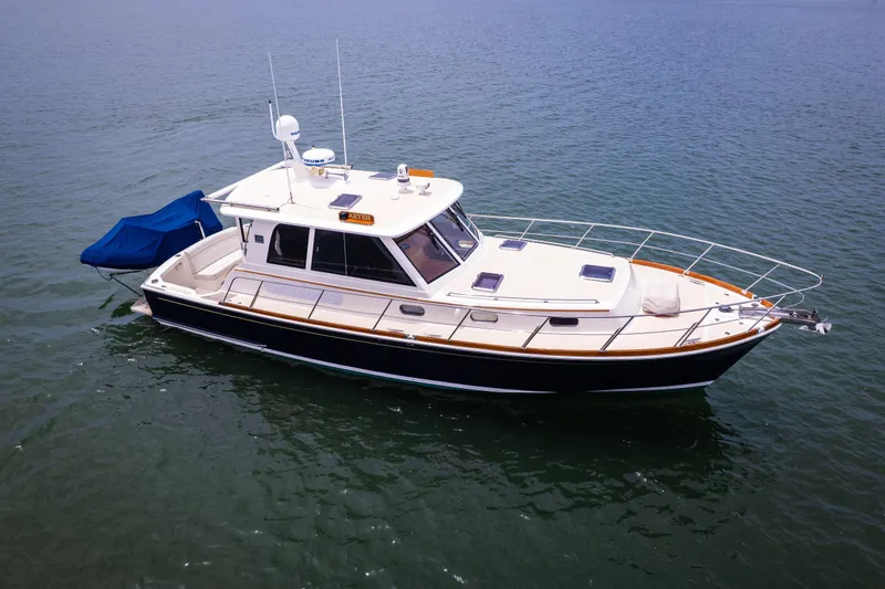 Aryeh Yacht Photos Pics 2008 Grand Banks EASTBAY 39 SX yacht on calm water, side view.