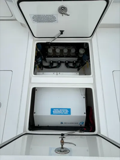  Yacht Photos Pics 2023 Contender 39 ST boat compartment with open hatches and visible equipment.