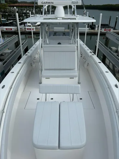  Yacht Photos Pics 2023 Contender 39 ST boat with sleek white seating and advanced navigation equipment.