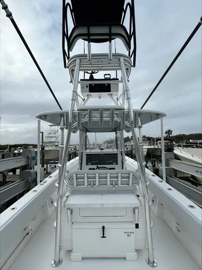  Yacht Photos Pics 2023 Contender 39 ST boat with tower, docked under cloudy skies.