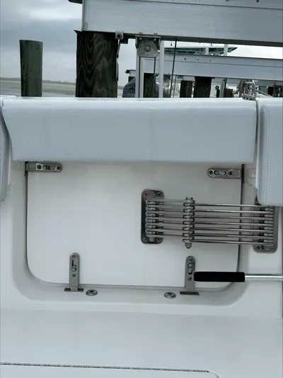  Yacht Photos Pics 2023 Contender 39 ST boat interior detail with sleek white seating and metal fixtures.