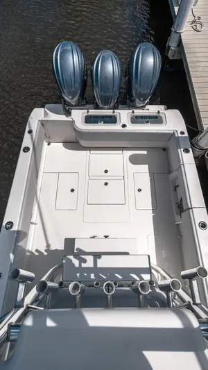  Yacht Photos Pics 2023 Contender 39 ST boat with triple engines, docked, showcasing spacious deck layout.