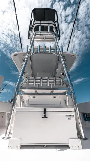  Yacht Photos Pics 2023 Contender 39 ST boat with tower against a blue sky backdrop.