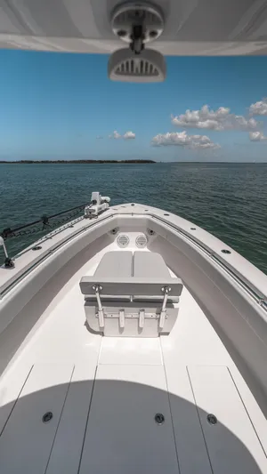  Yacht Photos Pics 2023 Contender 39 ST boat on open water under blue sky.