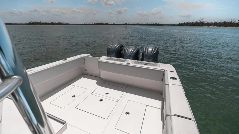  Yacht Photos Pics 2023 Contender 39 ST boat with triple engines on calm water.