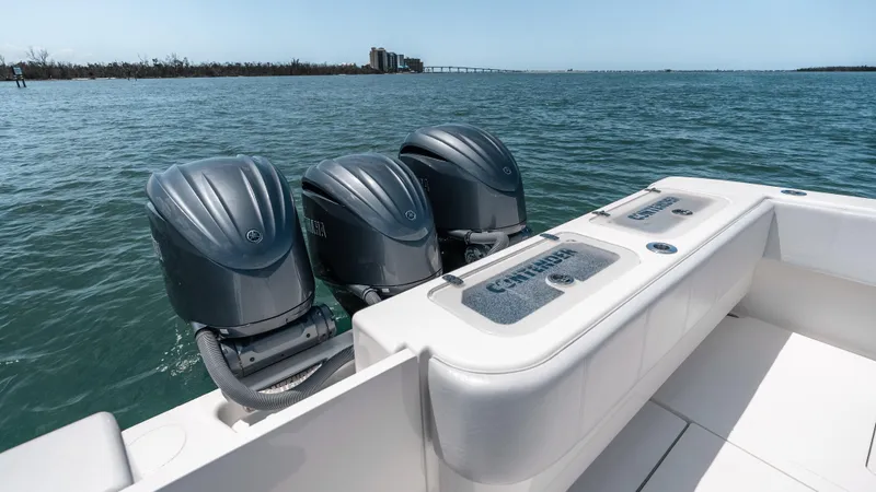  Yacht Photos Pics 2023 Contender 39 ST boat with triple outboard engines on open water.
