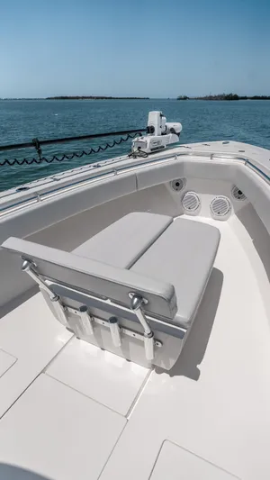  Yacht Photos Pics 2023 Contender 39 ST boat with cushioned seating, on calm waters.