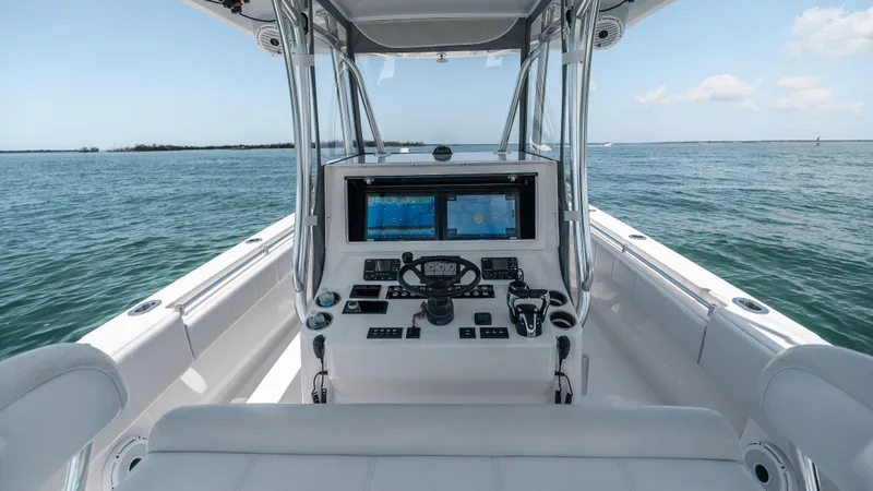  Yacht Photos Pics 2023 Contender 39 ST boat cockpit with advanced navigation system on open water.