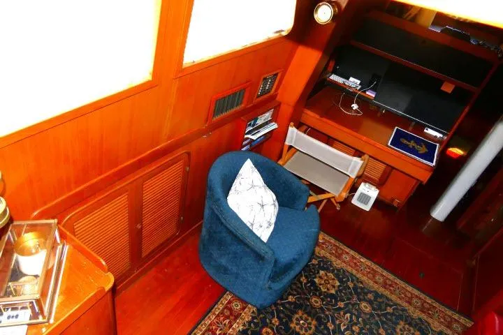 Avenir Yacht Photos Pics Interior of 1982 Ta Shing Mason 63 yacht with cozy seating and wooden decor.