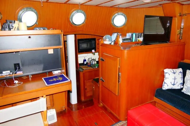 Avenir Yacht Photos Pics Interior of 1982 Ta Shing Mason 63 yacht with wooden furnishings and nautical decor.