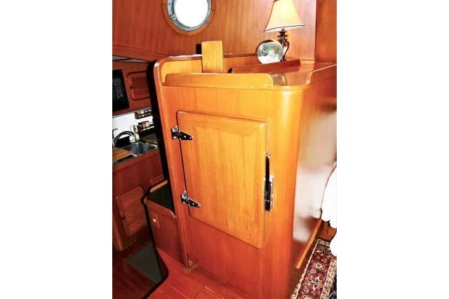 Avenir Yacht Photos Pics Interior of 1982 Ta Shing Mason 63 yacht with wooden cabinetry and nautical decor.