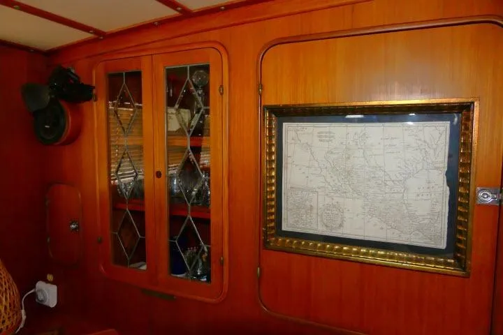 Avenir Yacht Photos Pics Interior of 1982 Ta Shing Mason 63 yacht with wooden cabinetry and framed nautical map.