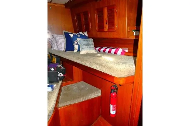 Avenir Yacht Photos Pics Cozy interior of 1982 Ta Shing Mason 63 yacht with cushions and fire extinguisher.