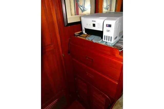 Avenir Yacht Photos Pics Wooden interior of 1982 Ta Shing Mason 63 yacht with a printer on a cabinet.