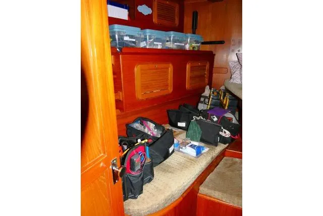 Avenir Yacht Photos Pics Interior of 1982 Ta Shing Mason 63 yacht with organized storage and wooden cabinetry.