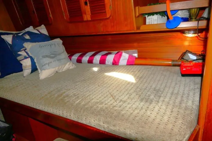 Avenir Yacht Photos Pics Cozy cabin interior of 1982 Ta Shing Mason 63 sailboat with cushions and wooden accents.