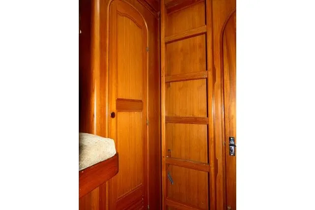 Avenir Yacht Photos Pics Interior of 1982 Ta Shing Mason 63 yacht with wooden cabinetry and ladder.