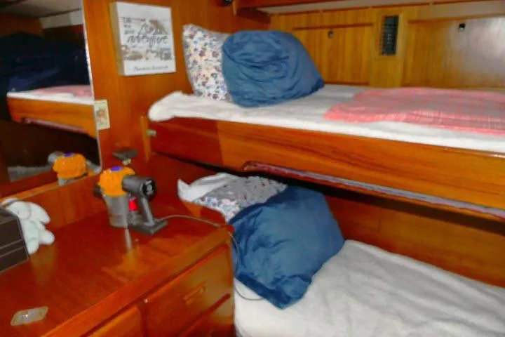 Avenir Yacht Photos Pics Interior of 1982 Ta Shing Mason 63 yacht with wooden bunk beds and cozy decor.