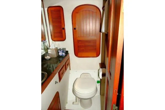 Avenir Yacht Photos Pics 1982 Ta Shing Mason 63 yacht bathroom with wooden cabinets and modern fixtures.