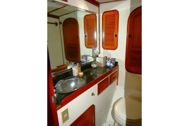 Avenir Yacht Photos Pics 1982 Ta Shing Mason 63 yacht bathroom with wooden cabinets and stainless steel sink.