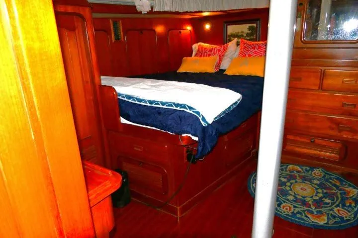 Avenir Yacht Photos Pics Luxurious wooden cabin interior of 1982 Ta Shing Mason 63 yacht with cozy bedding.