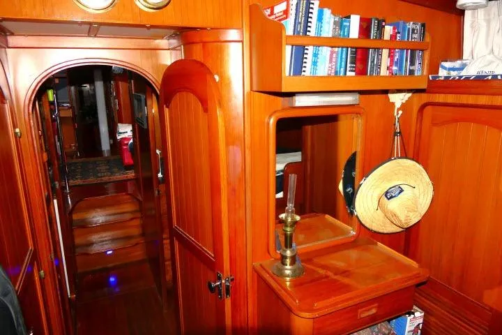 Avenir Yacht Photos Pics Interior of 1982 Ta Shing Mason 63 yacht with wooden cabinetry and bookshelves.
