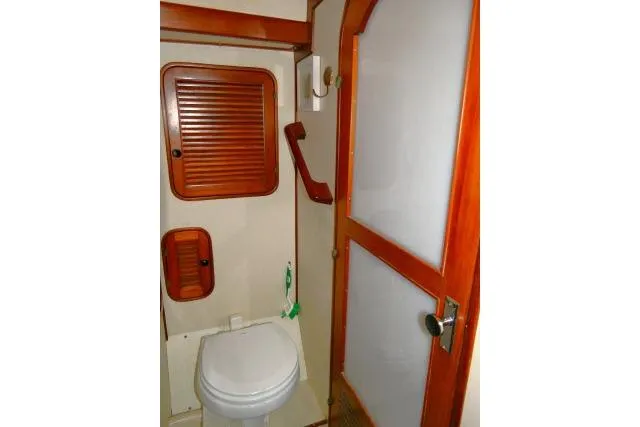 Avenir Yacht Photos Pics 1982 Ta Shing Mason 63 yacht bathroom with wooden accents and compact design.