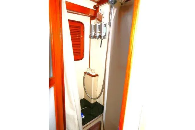 Avenir Yacht Photos Pics 1982 Ta Shing Mason 63 yacht shower with wooden trim and modern fixtures.