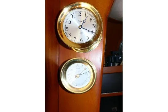 Avenir Yacht Photos Pics Brass clock and barometer on 1982 Ta Shing Mason 63 yacht interior.