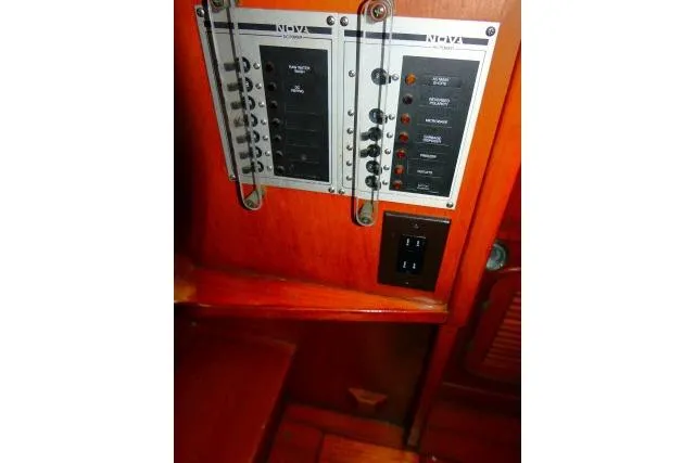 Avenir Yacht Photos Pics Electrical panel on 1982 Ta Shing Mason 63 yacht, featuring switches and wooden interior.