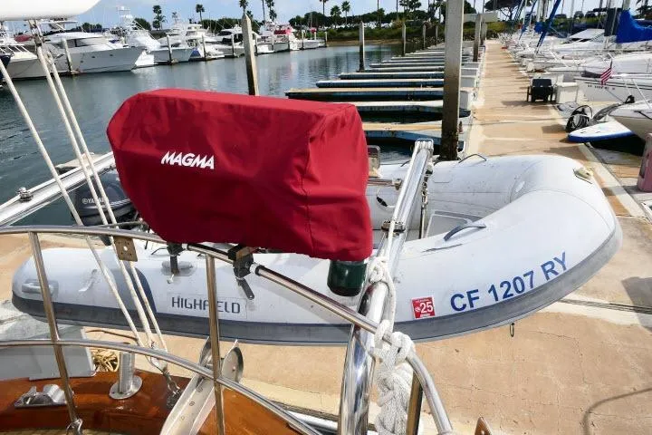 Avenir Yacht Photos Pics Docked 1982 Ta Shing Mason 63 yacht with inflatable boat and Magma grill cover.