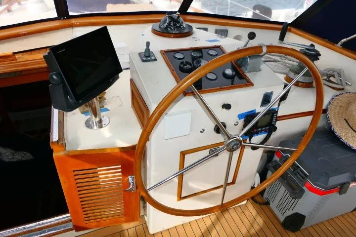 Avenir Yacht Photos Pics Helm of 1982 Ta Shing Mason 63 yacht with wooden wheel and navigation equipment.