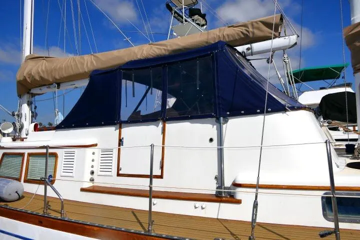 Avenir Yacht Photos Pics 1982 Ta Shing Mason 63 yacht with blue canopy and wooden deck details.