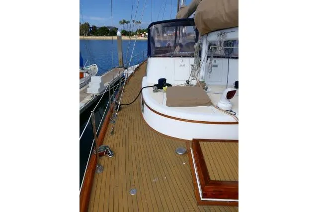 Avenir Yacht Photos Pics 1982 Ta Shing Mason 63 yacht deck with wooden finish and marina view.