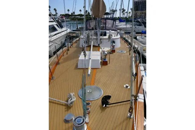 Avenir Yacht Photos Pics 1982 Ta Shing Mason 63 sailboat deck view at marina, showcasing teak wood finish.