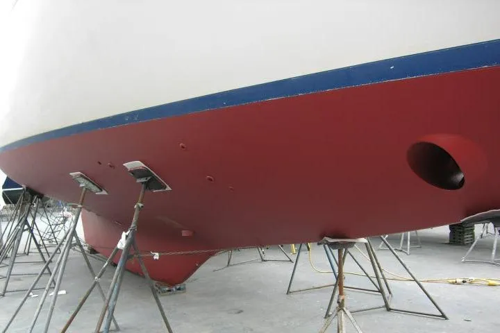 Avenir Yacht Photos Pics 1982 Ta Shing Mason 63 yacht hull on stands, showcasing red and blue paint.